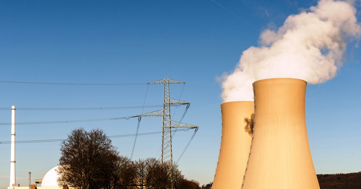 A nuclear power plant in Hameln, Germany, showcasing cooling towers and electricity pylons.